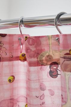 a pink curtain hanging from a metal rod