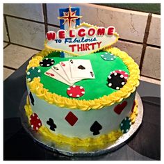 a cake that is sitting on top of a table in front of a tile wall