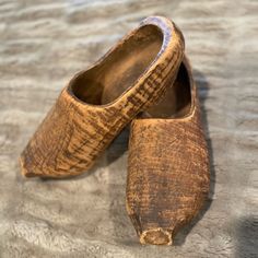 two wooden shoes sitting on top of a table