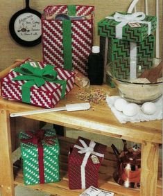 several wrapped presents sitting on a wooden table