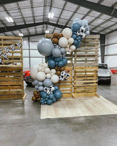 a bunch of balloons that are on some pallets in a warehouse with other items