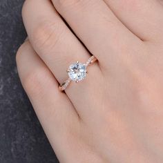 a woman's hand with a diamond ring on her finger and an engagement band