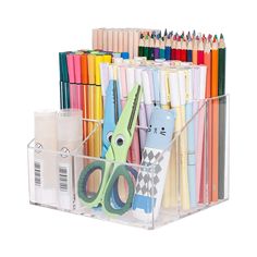 a clear container filled with lots of different colored pencils and scissors on top of each other