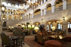 a large lobby with chandeliers and couches