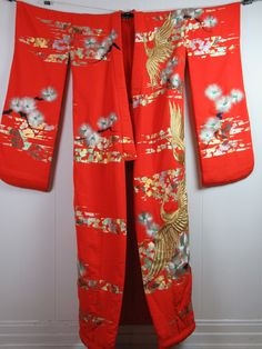 "Vintage 1960s mid century modern wedding kimono robe. Made of bright red/orange silk with metallic silver and gold embroidery. Long kimono with a padded trim hem at bottom. About a size medium. Actual measurements are: 51\" at the bust 51\" at the waist 24.5\" shoulder seam to shoulder seam 13\" shoulder seam to cuff 70\" overall length In very good condition. Has some wear to the bottom edge(photo)." Traditional Long Orange Kimono, Vintage Long Red Kimono, Vintage Red Long Kimono, Festive Kimono With Kimono Sleeves For Festivals, Traditional Spring Wedding Kimono, Vintage Red Kimono For Tea Ceremony, Long Vintage Kimono For Festivals, Traditional Red Kimono For Tea Ceremony, Red Long Sleeve Wedding Robe