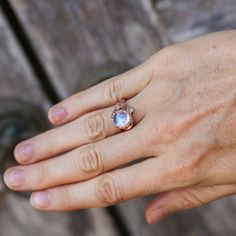 "The \"Cleo\" rose gold ring is the BlackTreeLab flagship moonstone engagement ring, which is now available in 14K Rose Gold for the most exquisite tastes. The ring can be made in Yellow or White 14K Gold on your request. There's a Rainbow Moonstone carefully selected by our master in the center place of this 14K gold flower ring which is ergonomically surrounded by detailed twigs, leaves and a beautiful rose. The \"Cleo\" is your right choice which will always deserve admires from all people ar Gold Moonstone Engagement Ring, Gold Ring Flower, Ring Gold Engagement, Women Gold Jewelry, Rainbow Moonstone Engagement Ring, Ring For Women Gold, Moonstone Engagement Ring Set, Gold Ring For Women, Gold Flower Ring