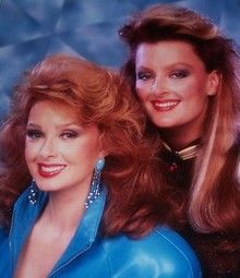 two women in blue leather jackets posing for a photo