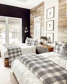 two beds in a room with black and white decor