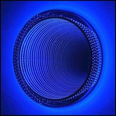 a circular blue light in the middle of a wall