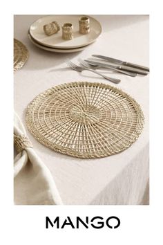 a table topped with plates and utensils on top of a white table cloth