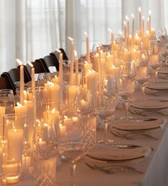 a long table with many candles on it