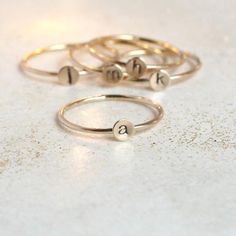 A teensy tinsy silver personalized initial ring so cute you'll fall in love!  This listing is for 14/20 gold filled. Customize this delicate stacking ring with the initial or symbol you desire for a very wearable, everyday ring.  The slim 1mm band and 4mm disk (slightly smaller than our original 5mm round - see comparison photo) makes this literally THE most perfect ring for stacking! Just the right find for a lucky momma or grandmother of many. Also sweet for creating a short word by stacking m Tiny Gold Initial Ring, Dainty Everyday Initial Ring, Tarnish Resistant, Gold Minimalist Personalized Initial Ring, Dainty Gold-plated Initial Ring, Dainty Yellow Gold Initial Ring, Adjustable, Personalized Initial Ring, Silver Initial Ring, Delicate Stacking Rings, Best Friend Rings