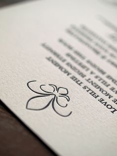 a close up of a business card with a clover on the front and back side