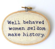 an embroidered quote is shown on a white wall hanging ornament with blue writing