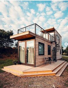 a small wooden house sitting on top of a lush green field