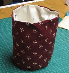 a bag sitting on top of a table next to a piece of paper and scissors