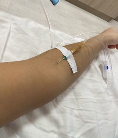 a person laying in bed with an iv attached to their arm