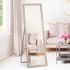 a living room filled with furniture and a large mirror in the middle of the room