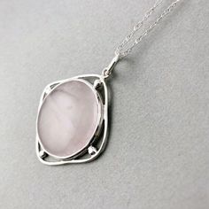 "A beautiful pendant featuring a large pink Rose Quartz bezel set in a diamond shaped frame. Made entirely of Sterling Silver. The pendant photographed is the one you will receive. Handmade in the USA. Dimensions: The Rose Quartz is 25mm (1\" inch). The entire pendant is 30mm in diameter (1 1/4\" inch). Bale measures 8mm wide and 3mm thick." Elegant Pink Jewelry With Large Pendant, Pink Sterling Silver Jewelry With Large Pendant, Geometric Rose, Pendant Diamond, Pink Rose Quartz, Rose Quartz Pendant, Custom Earrings, Quartz Rose, Jewellery Ideas