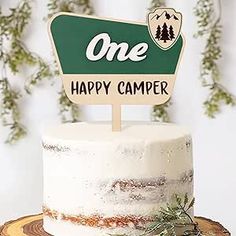 there is a cake that has a one happy camper sign on top of it