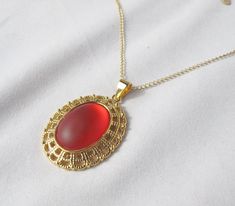 "This bright cherry red pendant is perfect for Christmas, but you don't have to wait till then to wear it! The chain is long enough to wear over cowl-neck sweaters, but the necklace is a nice light weight and won't pull you down! The settings is a sparkling fancy gold two-tier filigree. The photos don't do it justice, as the cabochon catches the light with a soft glow! Necklace Length: 30\" with 2\" extension Pendant Length: 1.75\" Pendant Width: 1.25\" Featured bead: Lunasoft 25x18mm cherry oval cabochon Clasp: Lobster claw To make this necklace, I glued the cabochon onto the setting and let it cure. Then I threaded the chain through the bail. This is a simple pendant, but is large enough to look good on a bulky sweater! Perfect for Winter, Spring and Fall...and maybe even Summer!" Bulky Sweater, Glow Necklace, Bulky Sweaters, Red Pendant, Simple Pendant, Red Pendants, Cowl Neck Sweater, Oval Cabochon, Cherry Red