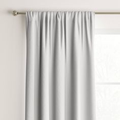 a white curtain hanging on the side of a window