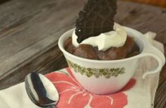 a chocolate dessert in a bowl with whipped cream on top