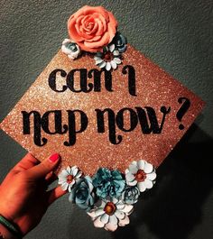 someone holding up a graduation cap with flowers on it that says can't map now?