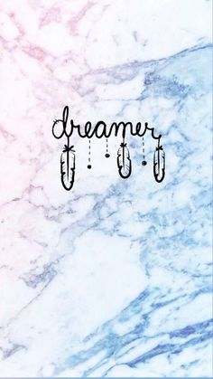 the word dream written in cursive writing on a marble background with hooks hanging from it