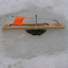 a toy boat in the snow with an orange flag