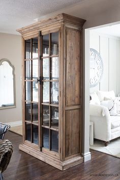 a large wooden cabinet sitting in the middle of a living room