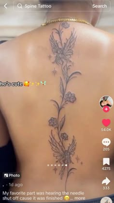 the back of a woman's neck with flowers on it and an arrow in the middle