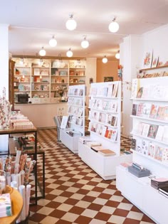 the inside of a book store with lots of books on shelves and checkered flooring