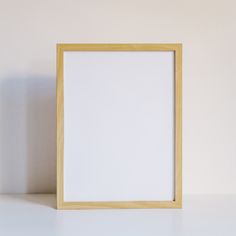 an empty wooden frame sitting on top of a table