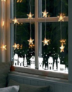 the window is decorated with christmas lights and stars