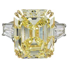 This Art Deco-inspired platinum and 18K gold ring made by Spectra Fine Jewelry in 2022 is stunning as a cocktail, engagement, or celebration ring, featuring a very large emerald-cut fancy yellow diamond, weighing approximately 23.16 carats. The diamond is accompanied by report from the Gemological Institute of America (GIA) stating that it is a natural diamond of fancy yellow color and even distribution with VS1 clarity. The central stone is accented with two tapered baguettes of I color and VS2 Loui Vuttion, Celebration Ring, Fancy Yellow Diamond Ring, Diamond Gifts, Yellow Diamond Ring, Canary Diamond, Yellow Diamond Engagement Ring, Yellow Diamond Rings, Fancy Yellow Diamond