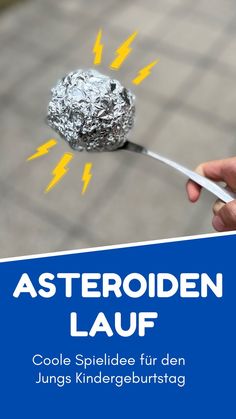 a person holding a metal object in their hand with the words asteroiden lauf on it