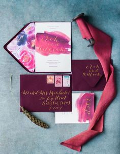 the wedding stationery is laid out on top of each other, including an envelope