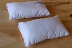 two pillows sitting on top of a wooden table