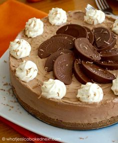 a chocolate cake topped with cookies and whipped cream