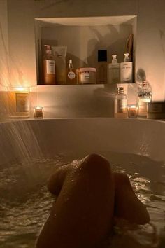 a bathtub filled with lots of soap and candles