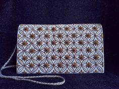 "Add instant glamour and elegance to any ensemble with this one-of-a-kind statement clutch, expertly hand embroidered in antique gold and bronze colored metallic threads on blue slate gray velvet background and embellished with genuine garnets, to create a luxurious, textured and dazzling effect. This beautiful handbag glows and sparkles in the most alluring way... Versatile - wear it on the shoulder for hands free convenience, or wear it in the hand with a double loop, or remove the strap. Goes Gold Clutch With Mirror Work For Reception, Gold Clutch With Mirror Work For Formal Occasions, Gold Clutch Evening Bag With Mirror Work, Gold Evening Bag With Mirror Work, Traditional Gold Clutch With Mirror Work, Velvet Background, Embellished Purses, Purse Luxury, Statement Clutch