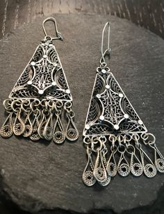 Apair of  sterling earrings--vintage hand wrought filigree long drop with fringe.  Condition I see no problems, marked 925 on backs.  I believe they are from the first half of the 1900s and either European, middle eastern or Egyptian.  Length 2 1/2", lots of interesting design and movement.  The time to design and form and soder all the parts is mind blowing-I've done studio unique pieces in silver over the years seeing this design and its execution leaves much to be appreciated by the skilled artist that made them.  They will move like rain when worn. Vintage Sterling Silver Chandelier Drop Earrings, Vintage Sterling Silver Chandelier Dangle Earrings, Vintage Sterling Silver Dangle Chandelier Earrings, Vintage Sterling Silver Chandelier Earrings, Ornate Sterling Silver Chandelier Earrings, Vintage Silver Chandelier Earrings, Handmade Silver Vintage Chandelier Earrings, Sterling Silver Filigree Dangle Chandelier Earrings, Silver Dangle Chandelier Earrings With Intricate Design