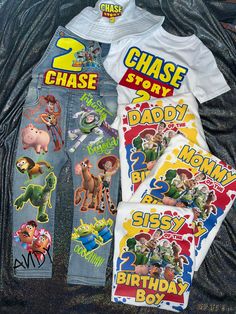 children's birthday shirts and jeans laid out on a bed with the name chase story printed on them