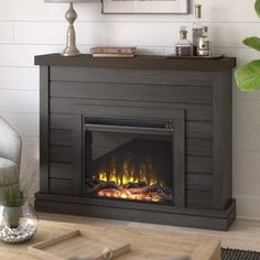 a living room with a fire place in the center and a painting on the wall