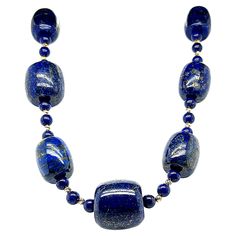 This impressive beaded necklace features rich, violetish blue lapis lazuli beads in large, graduating barrel shapes! The barrel shapes have been arranged and strung on silk thread, accented with perfectly uniform lapis round beads and bright, 14k yellow gold "diamond-cut" beads. The sparkling yellow gold beads beautifully accentuate the natural golden veining and pyrite flecks in the lapis. The barrel shaped beads graduate from 14.00 x 9.50mm to 20.00 x 20.00mm in size. This big and bold necklac Bold Necklace, Vintage Beads Necklace, Lapis Lazuli Beads, Blue Lapis Lazuli, Blue Lapis, Silk Thread, Gold Beads, Gold Accents, Lapis Lazuli