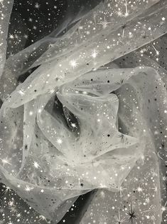 black and white photograph of stars in the night sky with sheer fabric on it's edge