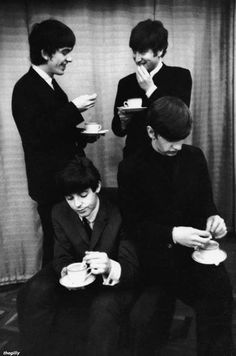 the beatles are drinking coffee and talking to each other