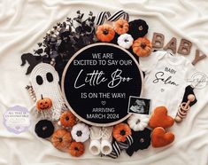 a baby announcement surrounded by halloween decorations