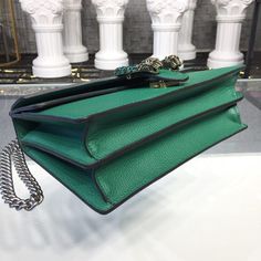 Description GG Dionysus Shoulder Bag Emerald Green Metal-Free Tanned For Women 11in/28cm GG 400249 CAOGX 3120 Rep 1:1 Measurements: 28 x 11 x 17 cm / 11 x 7 x 3.5 inches ( Length x Width x Height ) The Dionysus shoulder bag with the now defining tiger head closure-a unique detail referencing the Greek god Dionysus, who in myth is said to have crossed the river Tigris on a tiger sent to him by Zeus. The closure is further enhanced with black crystals. The sliding chain strap can be worn multiple God Dionysus, Green Metal, Gucci Bamboo, Greek God, Stylish Handbags, Tiger Head, Gucci Shoulder Bag, Luxury Products, A Tiger